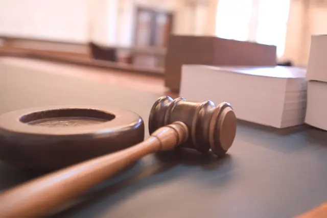 A gavel on a courtroom bench