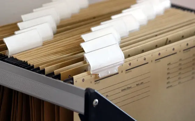 Stacked file folders and documents
